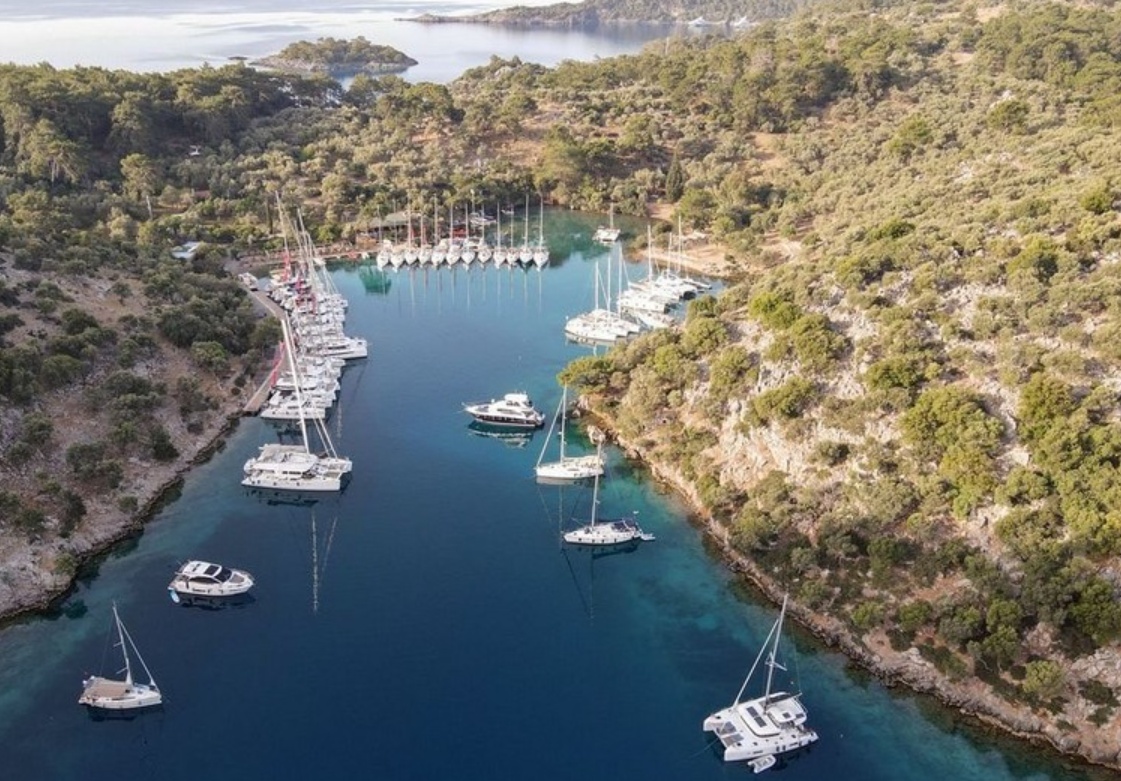 Aerial view of Göbün (Manastır) Bay in the Gulf of Göcek, with pine hills and calm water